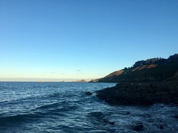 Scenic view of sea against clear blue sky