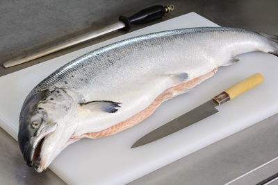 Fish on cutting board at table