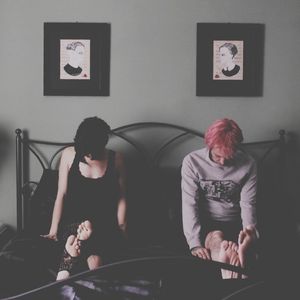 Displeased couple sitting in a bedroom