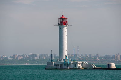 Lighthouse at the entrance to the harbor of odessa seaport, on a sunny summer day