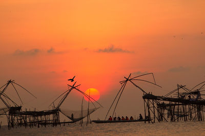 Silhouette fishing equipment in sea