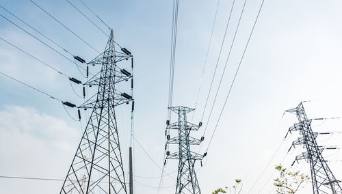 Low angle view of electricity pylon against sky