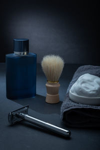 Closeup of men's toiletries, a razor, a shaving brush and some shaving foam.