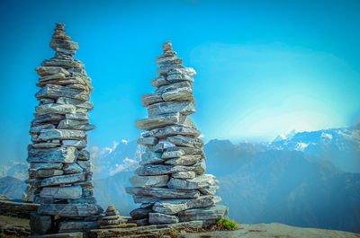 Stack of stones against blue sky