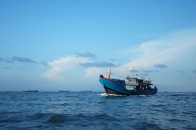 Boat sailing in sea against sky