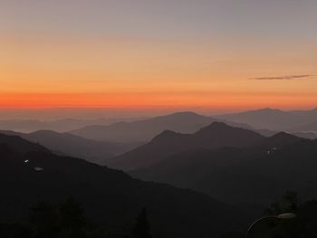 Scenic view of silhouette mountains against sky during sunset