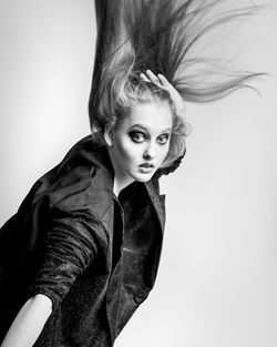 Portrait of woman against white background
