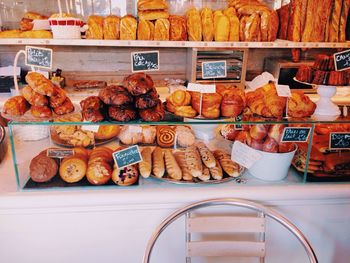 High angle view of various baked pastry items in display cabinet at bakery