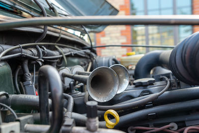 Detail view of the double horns of a classic offroad vehicle inside the engine bay