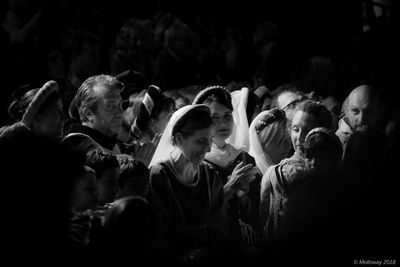 Group of people looking at friends at night