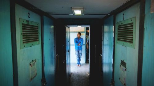 Portrait of man standing in corridor