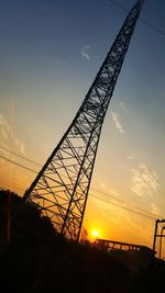 Low angle view of silhouette crane against sky during sunset