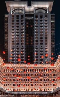 Low angle view of illuminated building in city