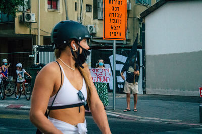 Woman standing on street in city