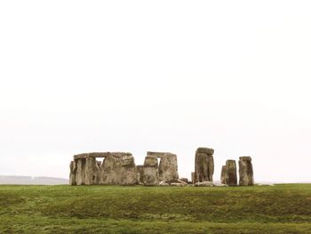 Old ruins on field against sky