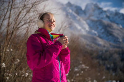 Full length of woman standing in snow