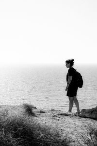 Full length of woman at beach against clear sky