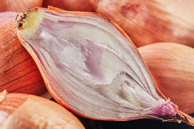 Purple onion lies on black plate on wooden background