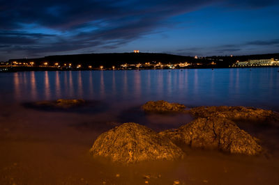 Illuminated city at waterfront