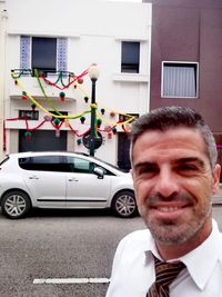 Portrait of smiling man in car