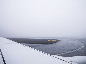 Airplane on runway against clear sky