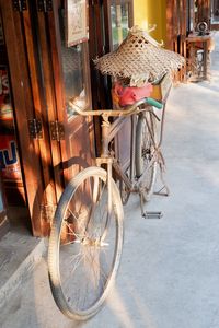 Bicycle in basket against building in city