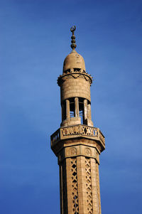 Low angle view of tower of building against blue sky