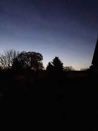 Silhouette trees against sky during sunset