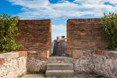 View of old building against cloudy sky