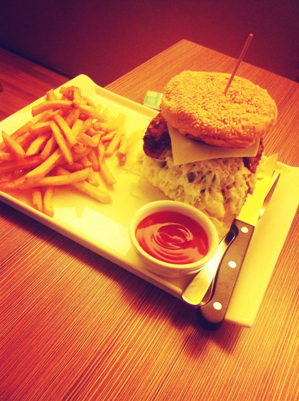 indoors, food and drink, table, food, still life, freshness, high angle view, ready-to-eat, close-up, sweet food, indulgence, unhealthy eating, slice, wood - material, no people, yellow, plate, dessert, red