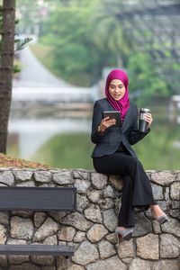 Young businesswoman wearing hijab using digital tablet