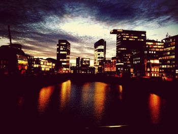 River in city against cloudy sky