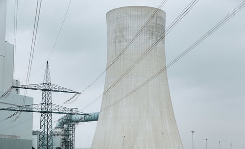 Low angle view of electricity pylon against sky