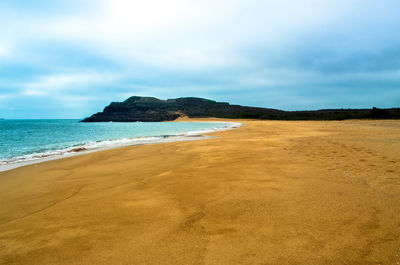 Scenic view of beach against sky