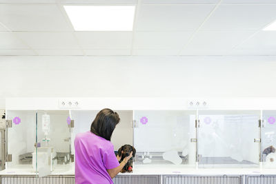 Rear view of woman standing in store