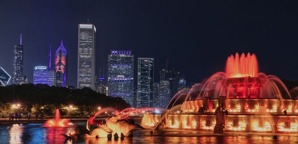 Illuminated buildings in city at night