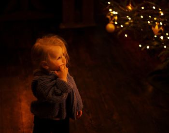 Girl looking at illuminated christmas lights