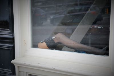 Low section of man on window