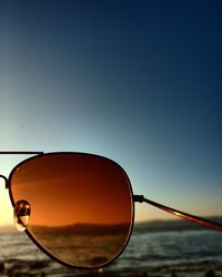 Close-up of sunglasses against clear sky