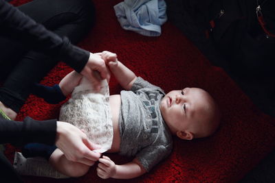 Rear view of baby lying on bed