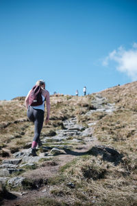 Woman climbing mountain 