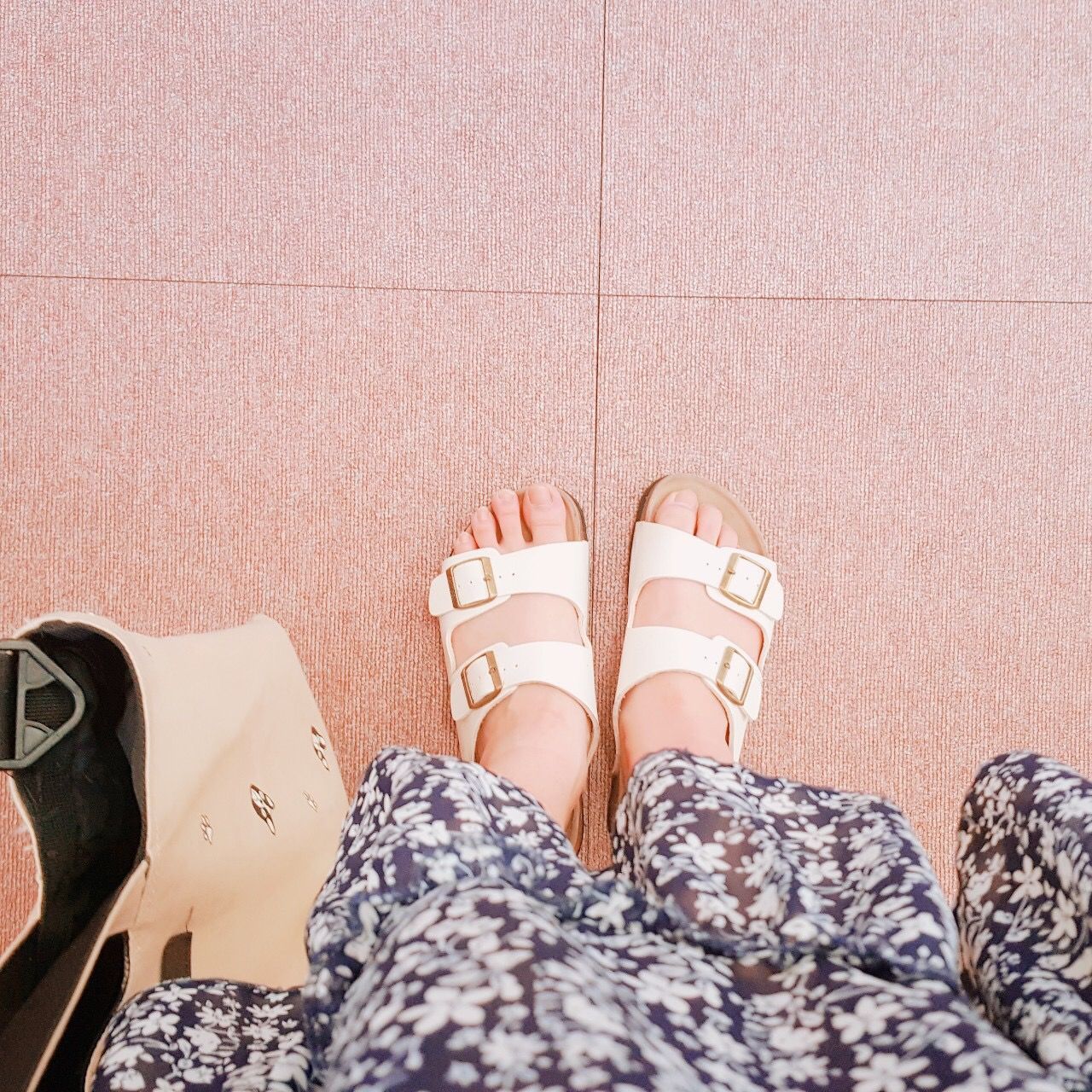 LOW SECTION OF WOMAN WEARING SHOES STANDING ON TILED FLOOR