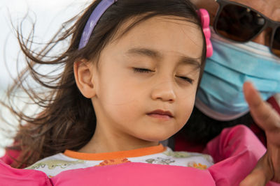 Close-up portrait of cute girl with eyes closed