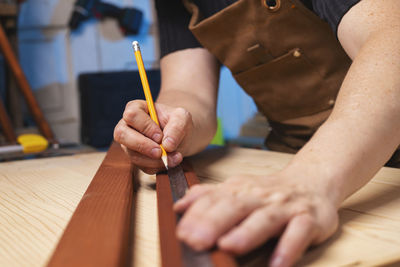 Midsection of woman painting on table