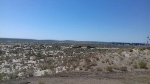 Scenic view of land against clear blue sky