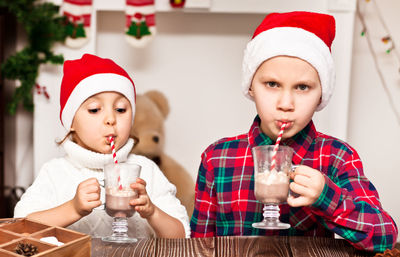 Boy and girl drinking hot chocolate during christmas