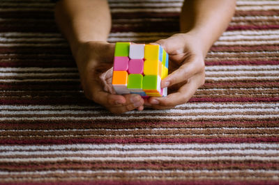 Person playing with toy cube
