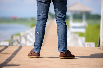 Low section of man standing on footpath