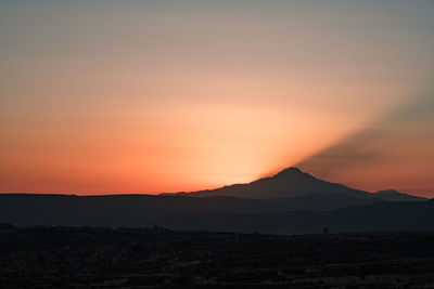 Scenic view of silhouette mountains against sky during sunset