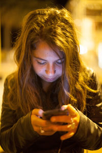 Close-up of young woman using smart phone